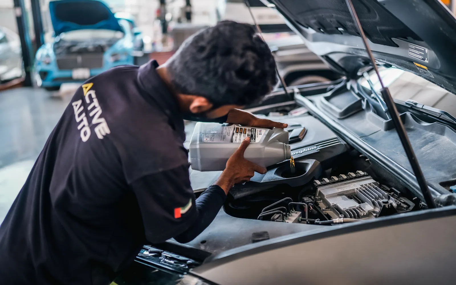 Active Auto technician servicing a premium SUV in Al Quoz, Dubai